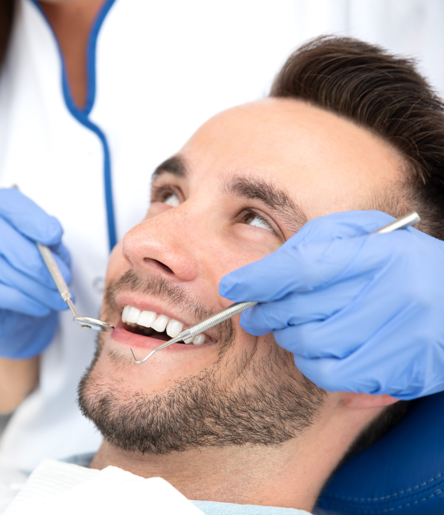 Man having teeth examined at dentists. Overview of dental caries prevention