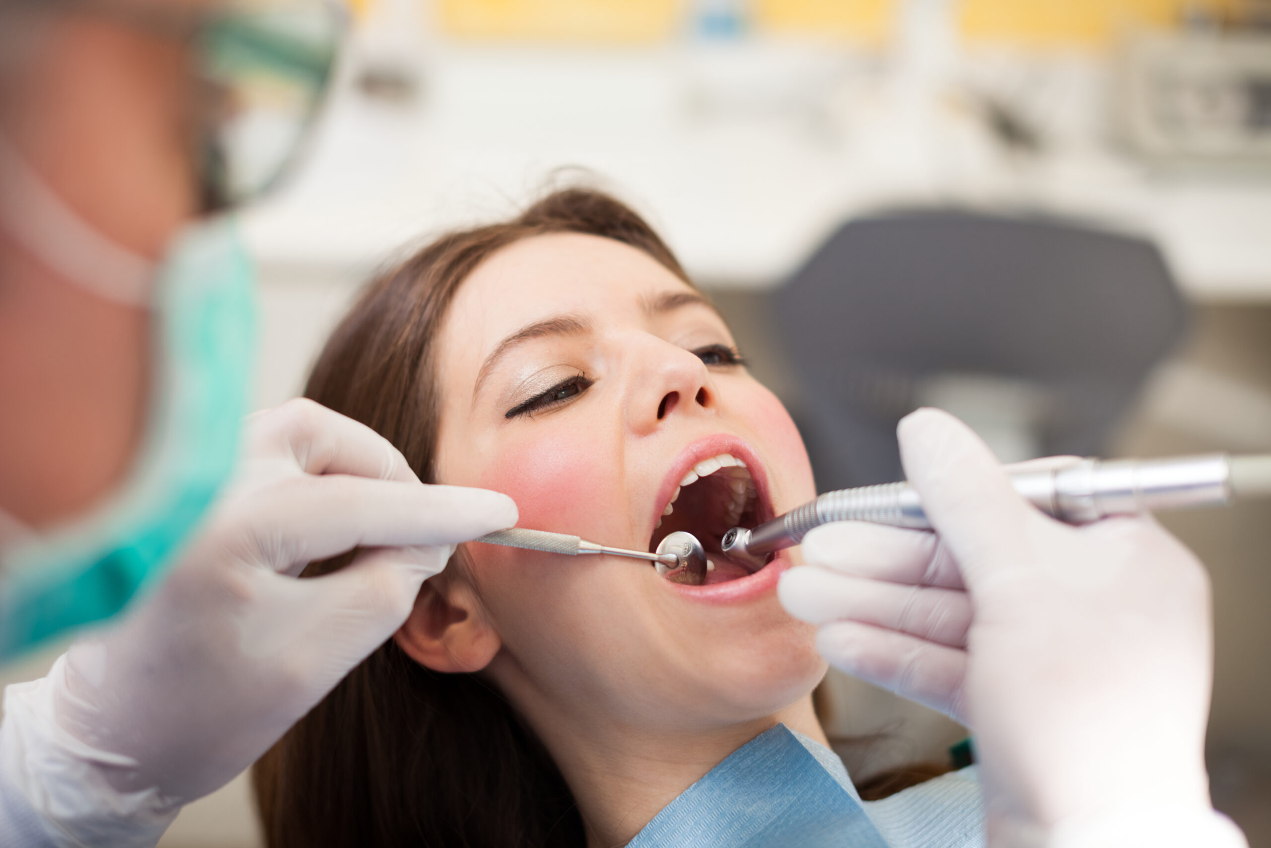 Dentist doing a dental treatment on a female patient