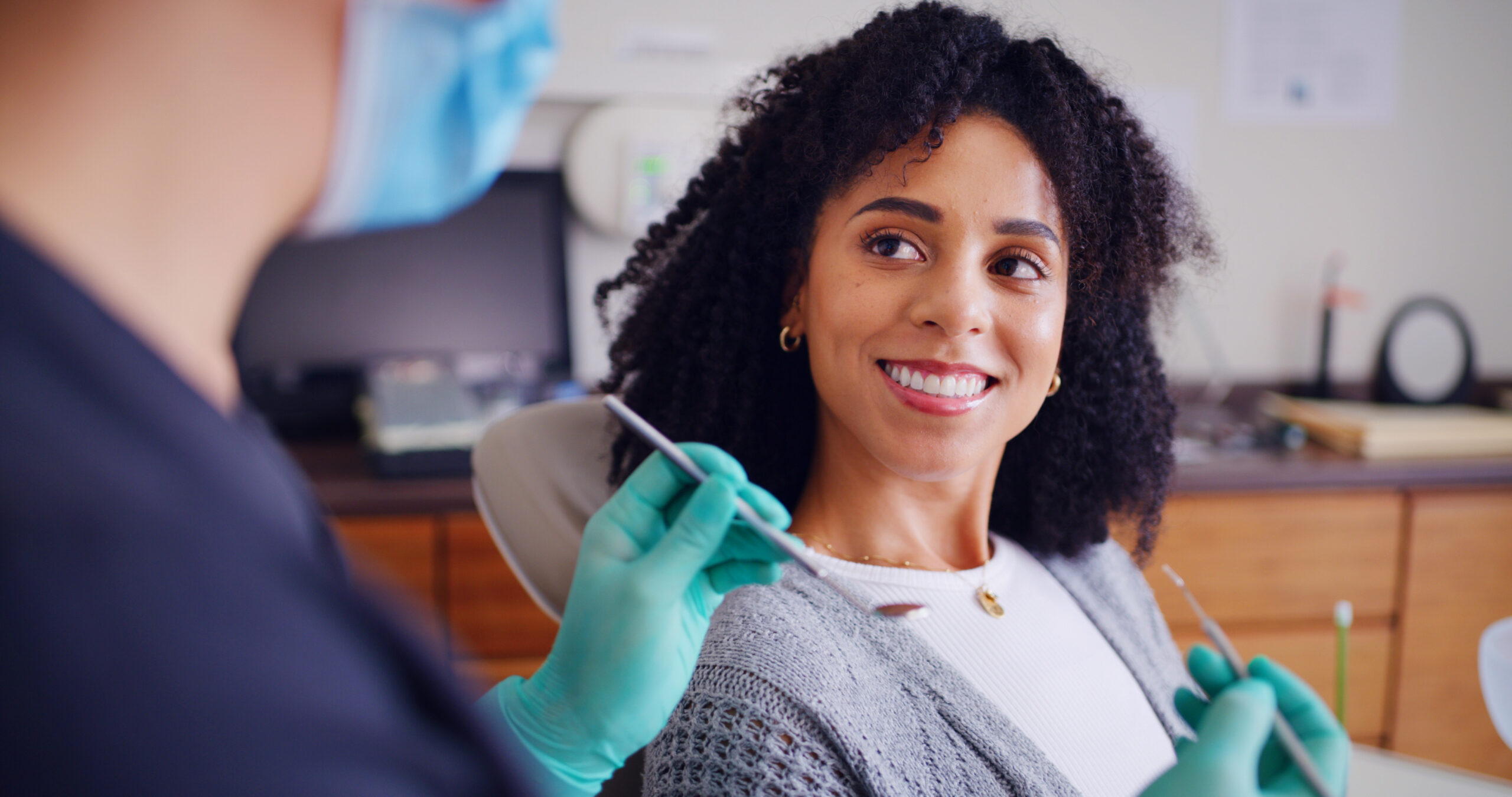 Dental, checkup or woman in clinic with smile, advice or examination for decay prevention. Healthcare, guidance or dentist in hospital with tools, consultation or teeth inspection for mouth health